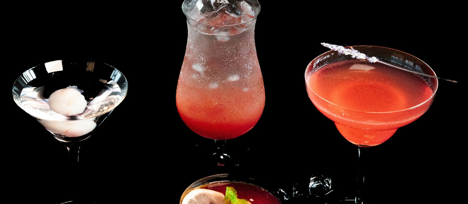 Zero-proof bottles and cocktails on a warmly lit table.